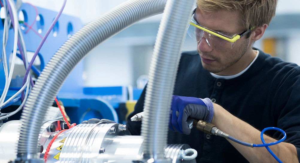 Aerospace Technician Working On Automation Machinery